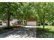 Charming brick home with a two-car garage and mature trees in a landscaped yard at 1147 Anduin Falls Dr, Charlotte, NC 28269