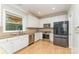 Modern kitchen with stainless steel appliances, white cabinets, granite counters and bright natural light at 1147 Anduin Falls Dr, Charlotte, NC 28269