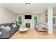 Open-concept living room with hardwood floors, fireplace, and ample natural light at 1147 Anduin Falls Dr, Charlotte, NC 28269