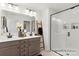 Modern bathroom with a double vanity, walk-in shower, and elegant finishes at 11619 Sapsucker Ln # 65, Charlotte, NC 28215