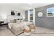 Comfortable bedroom with a cushioned headboard, coordinating decor, and natural light from the windows at 11619 Sapsucker Ln # 65, Charlotte, NC 28215