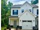 Charming two-story home with a white exterior, attached garage and well-manicured landscaping at 11619 Sapsucker Ln # 65, Charlotte, NC 28215