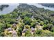Aerial view of a luxury neighborhood with mature trees near a large lake, showcasing an upscale residential community at 117 Lake Hills Dr, Mooresville, NC 28117