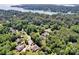 Aerial view of an upscale neighborhood nestled among mature trees, showcasing proximity to a large lake at 117 Lake Hills Dr, Mooresville, NC 28117