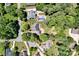 Aerial view of a home with a sparkling swimming pool surrounded by lush greenery and well-manicured lawns at 117 Lake Hills Dr, Mooresville, NC 28117