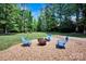 Backyard firepit with adirondack chairs, perfect for outdoor gatherings and relaxation at 117 Lake Hills Dr, Mooresville, NC 28117