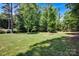 Expansive backyard with a lush green lawn, mature trees, and ample space for outdoor activities at 117 Lake Hills Dr, Mooresville, NC 28117