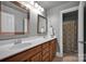 Bathroom featuring dual sinks with dark wood cabinets and a private toilet and shower at 117 Lake Hills Dr, Mooresville, NC 28117