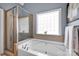 Bathroom featuring a glass-enclosed shower and a large soaking tub near a window at 117 Lake Hills Dr, Mooresville, NC 28117