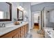 Bathroom with double sinks, wooden cabinets, and separate glass-enclosed shower and garden tub at 117 Lake Hills Dr, Mooresville, NC 28117