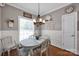 Cozy dining area with wood floors, modern lighting, and a charming decor and furniture at 117 Lake Hills Dr, Mooresville, NC 28117