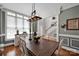 Stylish dining room with an ornate light fixture, large windows, and elegant decor at 117 Lake Hills Dr, Mooresville, NC 28117