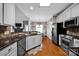 Open kitchen showcasing a stainless steel appliances, granite countertops and connection to a dining area at 117 Lake Hills Dr, Mooresville, NC 28117