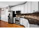 Kitchen features stainless steel appliances, granite countertops, and abundant white cabinetry for a functional space at 117 Lake Hills Dr, Mooresville, NC 28117