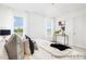 Large bedroom with a comfortable bed, stylish decor, and ample natural light streaming through the windows at 11716 Avocet St # 75, Charlotte, NC 28215