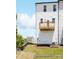 New construction home shows a white siding, a backyard deck, and a grassy lawn at 11716 Avocet St # 75, Charlotte, NC 28215