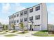 Charming townhome showcasing a two-story design, individual garages, and a well-manicured front lawn at 11716 Avocet St # 75, Charlotte, NC 28215