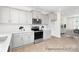 Bright kitchen features white cabinets, stainless steel appliances, white countertops, and wood look floors at 11716 Avocet St # 75, Charlotte, NC 28215