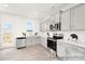 New kitchen featuring white cabinets, stainless steel appliances, white countertops, and access to a deck at 11716 Avocet St # 75, Charlotte, NC 28215