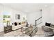 Light filled living room featuring contemporary decor, plenty of natural light, and a modern staircase at 11716 Avocet St # 75, Charlotte, NC 28215