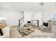 Spacious living room with stairs, contemporary furnishings, a modern rug, and bright natural light at 11716 Avocet St # 75, Charlotte, NC 28215