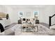 Inviting living room with contemporary furnishings, bright natural light, and modern staircase at 11716 Avocet St # 75, Charlotte, NC 28215