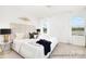 Bright and spacious main bedroom featuring a plush bed, elegant decor, and natural light from the windows at 11716 Avocet St # 75, Charlotte, NC 28215