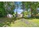 Lush backyard featuring a shed, outdoor seating, and a playful tire swing, offering versatile outdoor possibilities at 1215 Cardinal Dr # 9, Gastonia, NC 28052