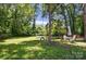 Spacious backyard offers a tranquil setting, complete with a tire swing and outdoor seating, perfect for recreation at 1215 Cardinal Dr # 9, Gastonia, NC 28052
