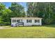 Charming one-story home features a well-maintained lawn, complemented by lush greenery and a welcoming front porch at 1215 Cardinal Dr # 9, Gastonia, NC 28052