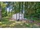 Practical outdoor shed provides ample storage space, set within a leafy backyard, for tools and equipment at 1215 Cardinal Dr # 9, Gastonia, NC 28052