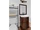 Bathroom featuring a dark vanity, storage, decorative mirror, and modern fixtures at 134 Snowbird Loop, Statesville, NC 28625