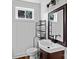 Bathroom showcasing dark vanity, decorative mirror, shelving, and modern fixtures at 134 Snowbird Loop, Statesville, NC 28625