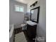 Clean and modern bathroom with shiplap walls, dark vanity and neutral accents at 134 Snowbird Loop, Statesville, NC 28625