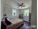 Cozy bedroom with hardwood floors, neutral walls, ceiling fan, and two bright windows at 134 Snowbird Loop, Statesville, NC 28625