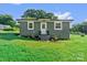 Charming home featuring a painted exterior, a well-manicured lawn, and tasteful landscaping at 134 Snowbird Loop, Statesville, NC 28625