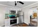 Bright kitchen featuring stainless steel appliances, green backsplash and white cabinetry at 134 Snowbird Loop, Statesville, NC 28625
