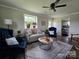Bright living room features hardwood floors, neutral walls, large windows and comfortable seating at 134 Snowbird Loop, Statesville, NC 28625