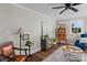 Cozy living room with wood-look flooring, neutral wall paint, stylish furniture, and a ceiling fan at 134 Snowbird Loop, Statesville, NC 28625