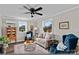 Bright living room featuring comfortable furniture, ample natural light, and a ceiling fan at 134 Snowbird Loop, Statesville, NC 28625
