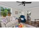Inviting living room features wood floors, a large window, and comfortable seating arrangements at 134 Snowbird Loop, Statesville, NC 28625