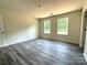 A bright bedroom featuring two windows, neutral paint, laminate flooring, and ample natural light at 139 Dove Creek Trl, Statesville, NC 28625