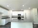 Modern kitchen boasts white cabinets, granite countertops, stainless steel appliances and a spacious island with a sink at 139 Dove Creek Trl, Statesville, NC 28625