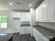 Newly constructed kitchen featuring bright white cabinetry, granite countertops, and stainless steel appliances at 139 Dove Creek Trl, Statesville, NC 28625