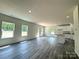 Open-concept living space with laminate floors, bright recessed lighting, neutral paint and multiple windows at 139 Dove Creek Trl, Statesville, NC 28625