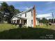 Two-story home with white siding, a covered front porch and a brick chimney at 1445 33Rd Sw St, Hickory, NC 28602