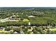 Aerial view of a residential neighborhood surrounded by lush trees and landscape, featuring a pond in the distance at 147 35Th Ne Ave, Hickory, NC 28601