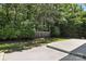 Secluded backyard with mature trees and lush greenery surrounding a concrete patio at 147 35Th Ne Ave, Hickory, NC 28601