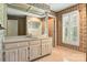 Bathroom featuring a large mirror above white vanity with drawers and a tub/shower combo at 147 35Th Ne Ave, Hickory, NC 28601