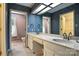 Full bathroom featuring double sinks, large mirrors, and bright wallpaper at 147 35Th Ne Ave, Hickory, NC 28601
